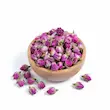 غنچه گل محمدی خشک شده در کاسه چوبی