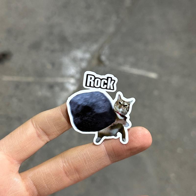 استيكر "گربه سنگ پرت كن"