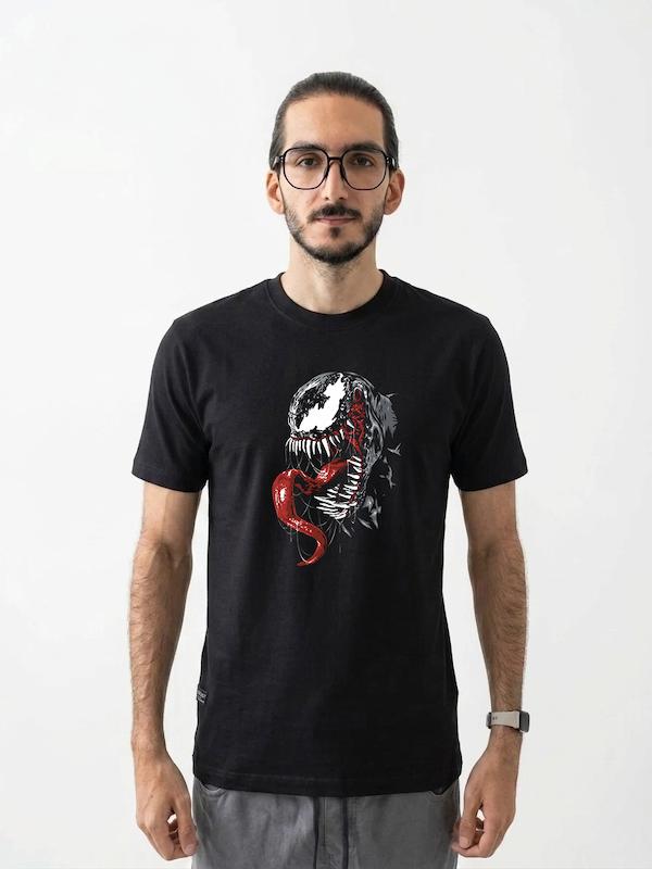 # تیشرت طرح Venom (3) | ونوم  **WE ARE VENOM**  تیشرت **طرح Venom (3)** یکی دیگر از مدل‌های مجموعه طراحی‌های ونوم در DMO SHOP است؛ انتخابی برای طرفداران شخصیت‌های تاریک، ضدقهرمان‌ها و دنیای کمیک **Marvel**. طراحی قدرتمند و فضای تیره این طرح، آن را به گزینه‌ای مناسب برای استایل‌های **Dark، Streetwear و Alternative** تبدیل کرده است.  اگر از طرفداران **Venom، Spider-Man و Marvel** هستید و به طرح‌های گرافیکی متفاوت علاقه دارید، این مدل می‌تواند انتخاب جذابی برای شما باشد.  ## 🕷️ Venom؛ نماد سمت تاریک دنیای کمیک  ونوم یکی از شناخته‌شده‌ترین شخصیت‌های دنیای مارول است؛ موجودی سیمبیوت که با یک میزبان انسانی ترکیب می‌شود و شخصیتی متفاوت و قدرتمند را شکل می‌دهد.  آنچه Venom را از بسیاری از شخصیت‌های دیگر متمایز می‌کند، قرار گرفتن او در مرز میان **قهرمان و ضدقهرمان** است. ظاهر ترسناک، قدرت بالا و شخصیت غیرقابل‌پیش‌بینی او باعث شده ونوم به یکی از محبوب‌ترین کاراکترهای دنیای کمیک تبدیل شود.  ## 🖤 برای طرفداران Venom و Marvel  تیشرت **Venom (3)** برای کسانی طراحی شده که به شخصیت‌های تاریک و متفاوت علاقه دارند و می‌خواهند علاقه خود به دنیای کمیک را در استایل روزمره‌شان نشان دهند.  مناسب برای:  * طرفداران **Venom** * علاقه‌مندان به **Marvel** * طرفداران Spider-Man * دوستداران شخصیت‌های ضدقهرمان * علاقه‌مندان به **Comic Art** * طرفداران **Dark Art** * علاقه‌مندان به Graphic Design * گیمرها و علاقه‌مندان به Pop Culture * طرفداران **Streetwear و Alternative Style**  ## 🔥 یک طراحی برای یک شخصیت متفاوت  ونوم از آن دسته شخصیت‌هایی است که ظاهرش به‌تنهایی توجه را جلب می‌کند.  ترکیب رنگ تیره، فرم خاص بدن، چهره خشن و ویژگی‌های بصری منحصربه‌فرد، باعث شده این شخصیت برای طراحی‌های گرافیکی و پوشاک انتخابی بسیار جذاب باشد.  تیشرت **Venom (3)** نیز از همین هویت بصری استفاده می‌کند تا یک آیتم متفاوت و چشمگیر برای استایل شما ایجاد کند.  **WE ARE VENOM.**  ## 👕 جنس و کیفیت تیشرت  برای تولید این محصول از **پارچه نخ پنبه خالص** استفاده شده است؛ پارچه‌ای نرم، راحت و مناسب استفاده روزمره.  این تیشرت را می‌توانید با **شلوار جین، کارگو، شلوار مشکی و آیتم‌های Oversized** ترکیب کنید و یک استایل Dark Streetwear بسازید.  ## 🎨 چاپ طرح Venom (3)  طرح **Venom (3)** با دقت روی پارچه اجرا شده تا جزئیات گرافیکی و فضای قدرتمند آن به خوبی دیده شود.  برای حفظ کیفیت چاپ و افزایش دوام آن، توصیه می‌شود تیشرت را با **آب سرد و طبق اصول صحیح شستشو** بشویید و از روش‌های نامناسب شستشو که ممکن است به چاپ آسیب بزند، خودداری کنید.  ## 🕸️ برای کسانی که سمت تاریک را انتخاب می‌کنند  همه قهرمان‌ها قرار نیست ظاهری تمیز و کلاسیک داشته باشند.  Venom نماینده بخشی تاریک‌تر از دنیای ابرقهرمانی است؛ شخصیتی که در مرز میان **خیر و شر، کنترل و خشم، انسان و موجود بیگانه** قرار گرفته است.  همین تضاد، یکی از دلایل اصلی جذابیت این شخصیت است.  تیشرت **Venom (3)** برای کسانی است که از این فضای متفاوت لذت می‌برند و می‌خواهند آن را وارد استایل خود کنند.  ## 📏 سایزبندی  تیشرت طرح **Venom (3)** در سایزهای استاندارد زیر ارائه می‌شود:  * **L** * **XL** * **XXL**  برای انتخاب دقیق سایز، قبل از ثبت سفارش حتماً **جدول سایزبندی** را بررسی کنید.  ## 🎨 رنگ‌بندی  این محصول در رنگ‌های موجود در صفحه محصول قابل سفارش است.  هنگام ثبت سفارش، **رنگ و سایز موردنظر** خود را انتخاب کنید.  ## 📦 ارسال رایگان به سراسر ایران  **ارسال این محصول به تمام نقاط ایران رایگان است.**  ## 🛒 چرا تیشرت طرح Venom (3)؟  * طراحی با الهام از **Venom** * مناسب طرفداران Marvel و Spider-Man * مناسب علاقه‌مندان به شخصیت‌های ضدقهرمان * مناسب طرفداران Dark Art و Comic Art * انتخابی جذاب برای استایل Dark و Streetwear * مناسب علاقه‌مندان به Graphic و Pop Culture * پارچه **نخ پنبه خالص** * چاپ با اجرای دقیق * مناسب استفاده روزمره * سایزبندی **L / XL / XXL** * ارسال رایگان به سراسر ایران  ---  ### مشخصات محصول  | ویژگی          | مشخصات                        | | -------------- | ----------------------------- | | **نام محصول**  | تیشرت طرح Venom (3)           | | **دسته‌بندی**  | دارک آرت                      | | **جنس**        | نخ پنبه خالص                  | | **سایز**       | L / XL / XXL                  | | **سبک**        | Venom / Marvel / Dark Art     | | **مناسب برای** | طرفداران Venom و دنیای Marvel | | **ارسال**      | رایگان به سراسر ایران         |  ---  ### کلمات کلیدی مرتبط  تیشرت Venom، تیشرت ونوم، تیشرت طرح Venom، تیشرت Venom 3، تیشرت ونوم 3، تیشرت Marvel، تیشرت مارول، تیشرت Spider-Man، تیشرت اسپایدرمن، تیشرت ضدقهرمان، تیشرت Anti Hero، تیشرت Venom Marvel، تیشرت Eddie Brock، تیشرت دارک آرت، تیشرت Dark Art، تیشرت کمیک، تیشرت Comic، تیشرت Graphic، تیشرت گرافیکی، تیشرت Streetwear، تیشرت Alternative، تیشرت Superhero، تیشرت ابرقهرمانی، تیشرت طرح خاص، تیشرت مشکی Venom، لباس Venom، تیشرت شخصیت مارول
