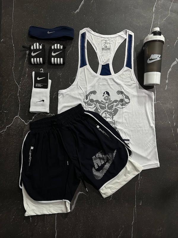 پکیج کد E1878 شامل رکابی قهرمانی + شلوارک کشاله دار + جوراب ساقدار + شیکر دو تیکه + مچ بند چسب نانو + هدبند با تم سفید سرمه ای🤍🔥