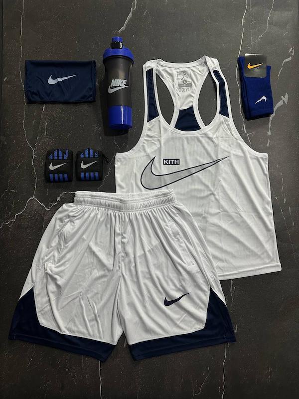 پکیج کد S3182 شامل رکابی قهرمانی + شلوارک + اسکارف + مچبند چسب نانو + جوراب ساقدار + شیکر دو تیکه با تم سفید سرمه ای