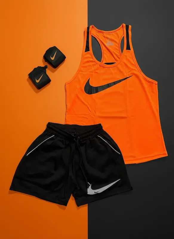 پکیج کد S3284 شامل رکابی قهرمانی + شلوارک + مچ بند چسب نانو با تم نارنجی مشکی