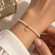 دستبند زنانه طلا ۱۸ عیار دستبند مروارید و ستاره مینیمال ری گلد