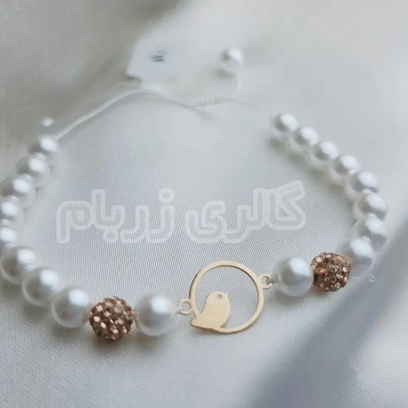 دستبند زنانه طلا ۱۸ عیار بند مروارید طرح پرنده گالری زربام