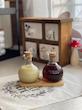 بطری شیشه‌ای روغن و سرکه گرد با طراحی شیار‌دار و درب چوب‌پنبه‌ای