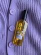 روغن مو گلیس Daily Oil-Elixir روی لباس بافتنی