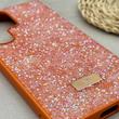 قاب گوشی Galaxy S24 Ultra سامسونگ نگین دار سواروسکی SWAROVSKI پلاک فلزی نارنجی کد 151355