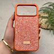 قاب گوشی iPhone 17 Pro Max آیفون نگین دار سواروسکی SWAROVSKI پلاک فلزی نارنجی کد 151404