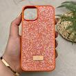 قاب گوشی iPhone 13 - 14 آیفون نگین دار سواروسکی SWAROVSKI پلاک فلزی نارنجی کد 151440