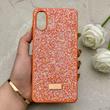 قاب گوشی Galaxy A07 سامسونگ نگین دار سواروسکی SWAROVSKI پلاک فلزی نارنجی کد 150790