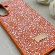 قاب گوشی Galaxy A56 سامسونگ نگین دار سواروسکی SWAROVSKI پلاک فلزی نارنجی کد 152998
