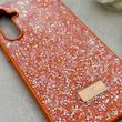 قاب گوشی Galaxy S23 FE سامسونگ نگین دار سواروسکی SWAROVSKI پلاک فلزی نارنجی کد 153036