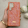 قاب گوشی Galaxy S25 Ultra سامسونگ نگین دار سواروسکی SWAROVSKI پلاک فلزی نارنجی کد 153049