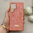 قاب گوشی Galaxy S25 Ultra سامسونگ نگین دار سواروسکی SWAROVSKI پلاک فلزی نارنجی کد 153049