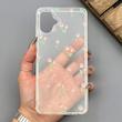 قاب گوشی Galaxy A06 سامسونگ شفاف پشت طلقی شیشه‌ای دور ژله ای طرح گل لاله