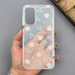 قاب گوشی Galaxy A15 سامسونگ شفاف پشت طلقی شیشه‌ای دور ژله ای طرح گل آبی