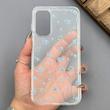 قاب گوشی Galaxy A15 سامسونگ شفاف پشت طلقی شیشه‌ای دور ژله ای طرح گل آبی 