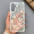 قاب گوشی Galaxy A17 سامسونگ شفاف پشت طلقی شیشه‌ای دور ژله ای طرح گل سفید