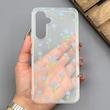 قاب گوشی Galaxy A54 سامسونگ شفاف پشت طلقی شیشه‌ای دور ژله ای طرح گل آبی
