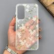 قاب گوشی Galaxy A55 سامسونگ شفاف پشت طلقی شیشه‌ای دور ژله ای طرح گل سفید