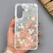قاب گوشی Galaxy A56 سامسونگ شفاف پشت طلقی شیشه‌ای دور ژله ای طرح گل سفید 