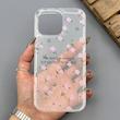 قاب گوشی iPhone 16 Pro Max آیفون شفاف پشت طلقی شیشه‌ای دور ژله ای طرح گل صورتی