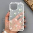 قاب گوشی iPhone 16 Pro Max آیفون شفاف پشت طلقی شیشه‌ای دور ژله ای طرح گل بابونه