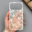 قاب گوشی iPhone 17 Pro Max آیفون شفاف پشت طلقی شیشه‌ای دور ژله ای طرح گل سفید