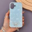 قاب گوشی iPhone 16 آیفون پاپیونی آویز مرواریدی نگین‌دار پشت سخت طرح فانتزی