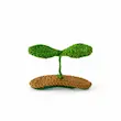 گیره مو بافتنی طرح جوانه دوبرگ سبز روی پایه قهوه‌ای روشن