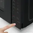 فشردن دکمه باز کردن درب در مایکروویو پاناسونیک مدل NN-ST34NB.