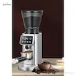 آسیاب قهوه مباشی مدل ME-CG2298 نقره‌ای در حال ریختن قهوه آسیاب شده مستقیم داخل پرتافیلتر.