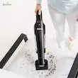 شخصی در حال استفاده از نازل مخصوص جارو شارژی شارک مدل CH950 برای نظافت یک صندلی پارچه‌ای کثیف