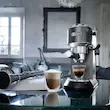 چیدمان هنری اسپرسو ساز دلونگی مدل EC685 رنگ خاکستری در کنار سازهای موسیقی و نوشیدنی لایه دار