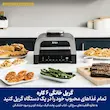 گریل و هواپز نینجا مدل DG551 با بدنه استیل و مشکی در کنار بشقاب‌های غذاهای گریل شده روی میز آشپزخانه