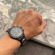 ساعت امگا سواچ مشکی روی دست از نمای دور 