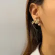 گوشواره طلایی طرح گره استیل میخ نقره فشن