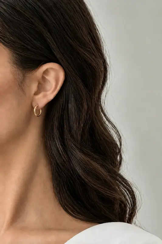 گوشواره حلقه‌ای کوچک طلایی ژوپینگ با بدنه باریک و ساده روی گوش