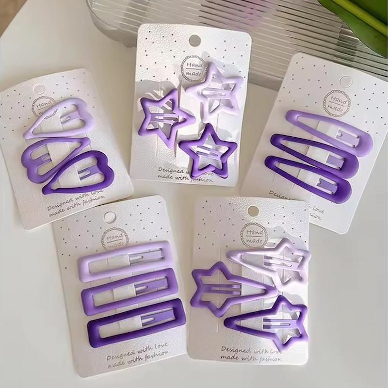 گیره مو تق تقی مات در طیف رنگی بنفش و یاسی با طرح های ستاره و قلب و بادومی و مستطیل - گلسر سوما