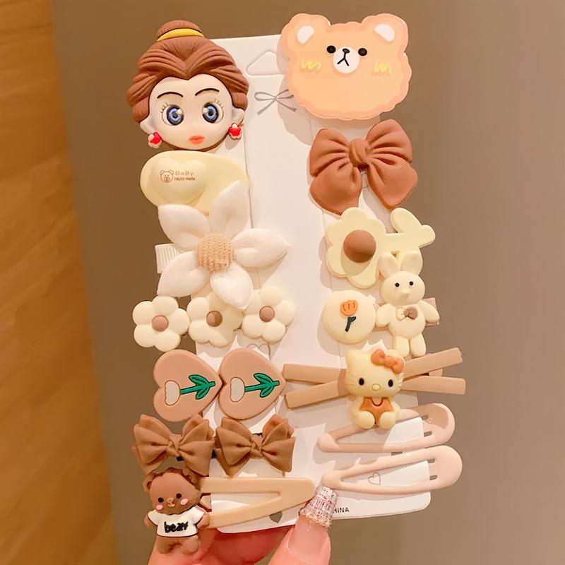 پک چهارده عددی اکسسوری مو شامل گیره های انبری و تق تقی با طرح های خرس تدی، کیتی و شخصیت دختر در رنگ های کرم و قهوه ای - گلسر سوما