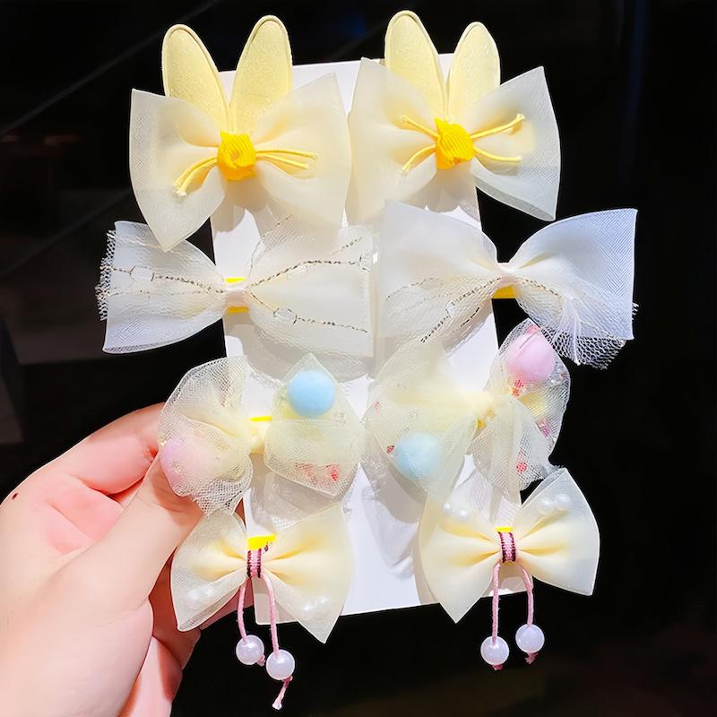 پک هشت عددی گیره مو پاپیون خریر زرد و توری با تزئینات مروارید و طرح های خرگوش فانتزی - گلسر سوما