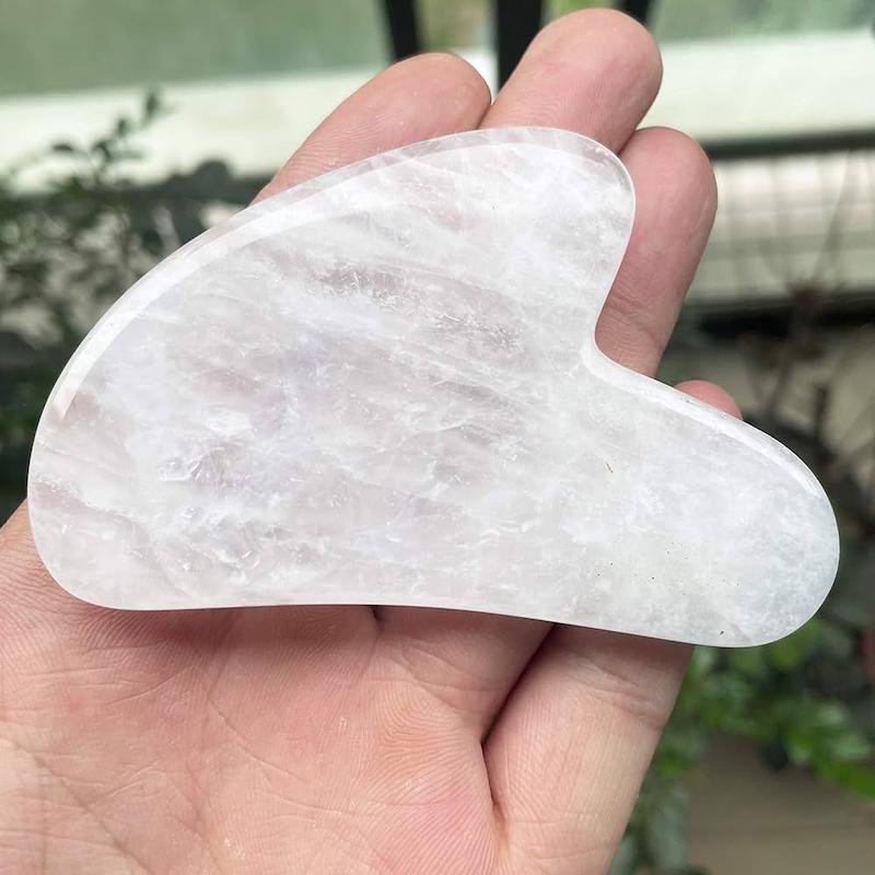 گواشا کوارتز شفاف | Clear Quartz Gua Sha برای لیفت، شفاف‌سازی و پاکسازی پوستابزار گواشا از سنگ کوارتز شفاف طبیعی برای ماساژ صورتگواشا کوارتز شفاف با طراحی ارگونومیک، مناسب برای افزایش شفافیت، تقویت جذب سرم، پاکسازی پوست و آرام‌سازی انرژی‌های منفی.